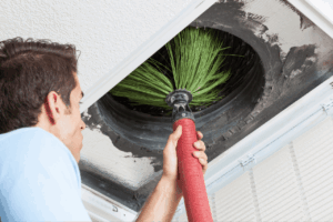 Professional technician cleaning residential air ducts