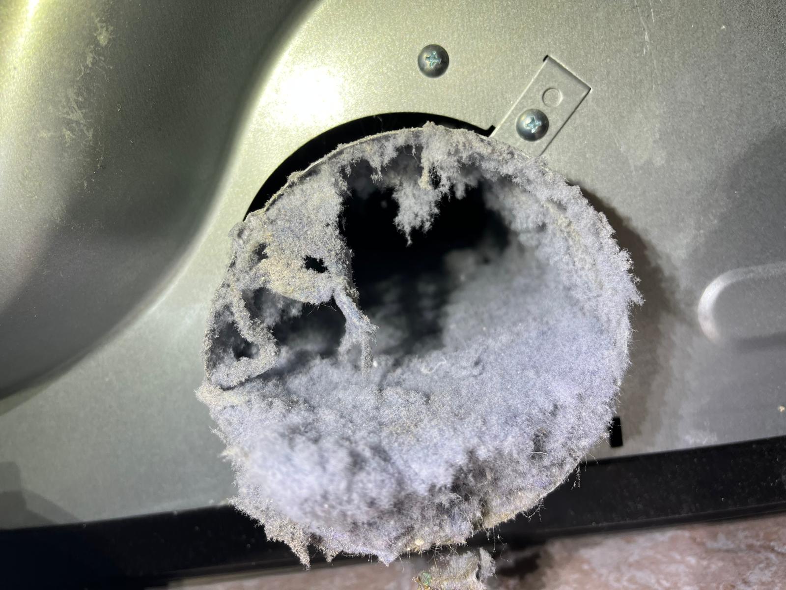 Dryer vent completely blocked with thick lint mat before SunDuct cleaning service on the Treasure Coast