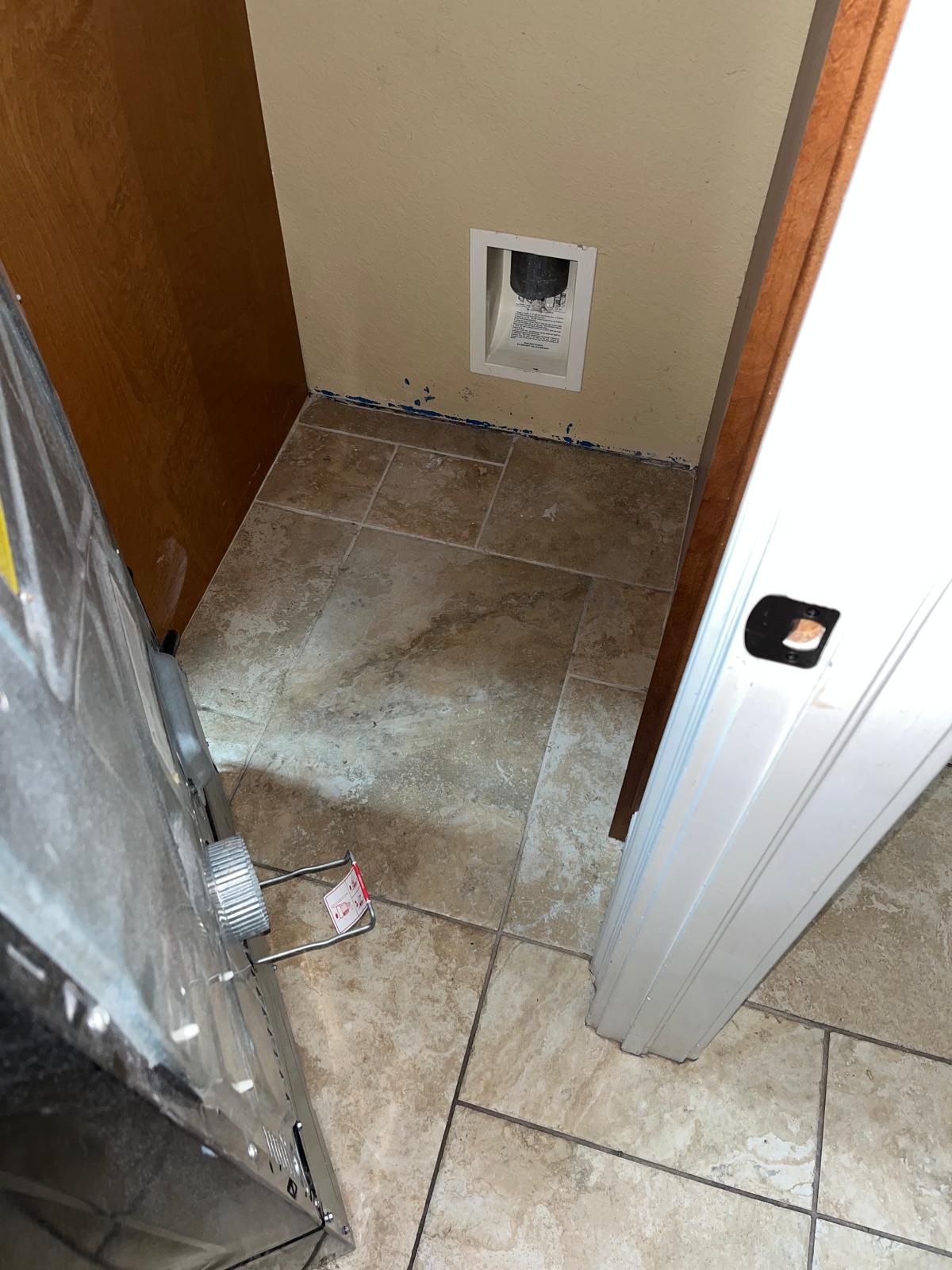 Florida laundry room dryer alcove showing the wall dryer vent connection point and surrounding area