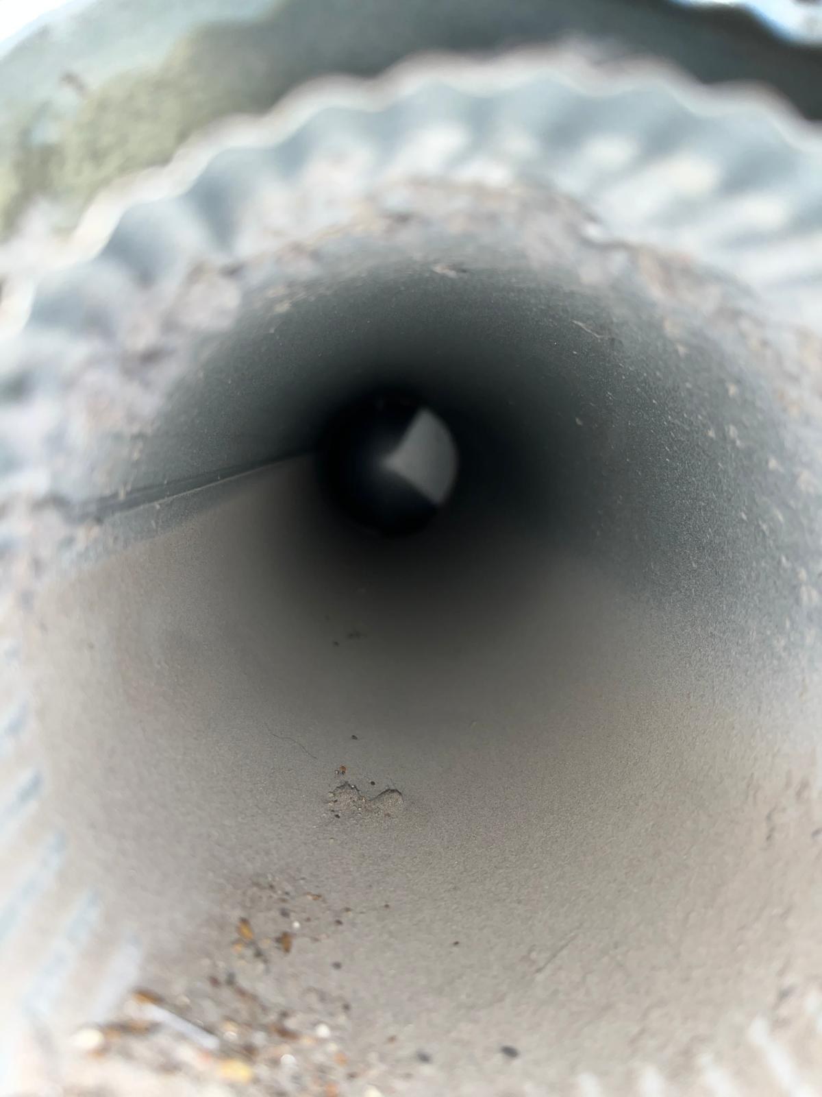 Inside a dust coated dryer duct before cleaning in Fort Pierce, FL