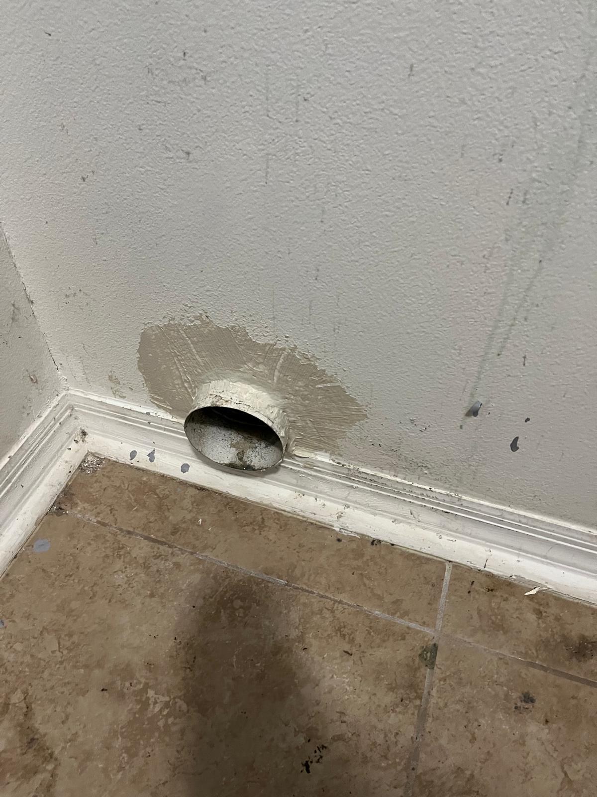 Clogged dryer vent connection in a Port St. Lucie home before cleaning