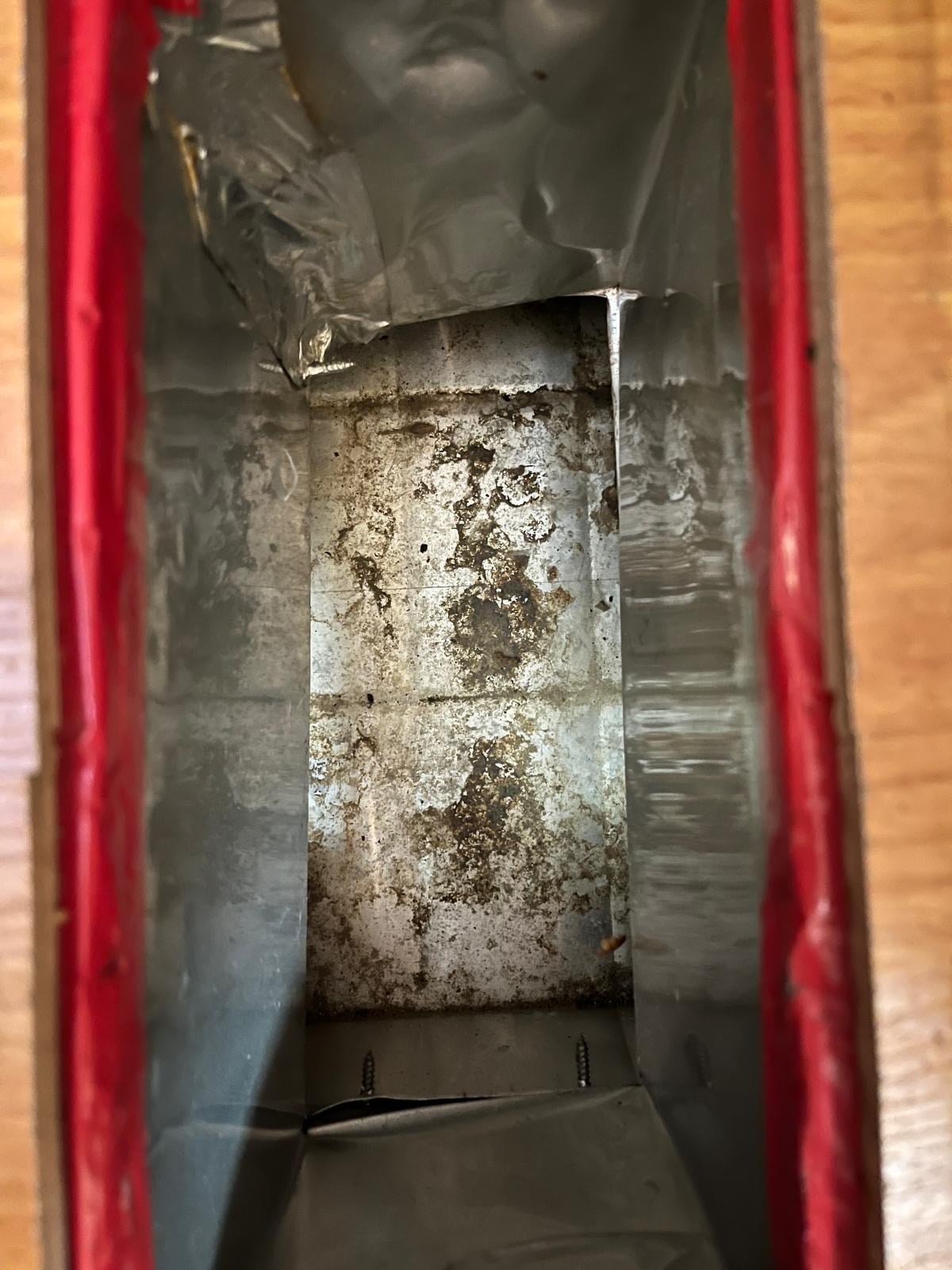 Grime and buildup inside a supply duct before cleaning in Jensen Beach, FL